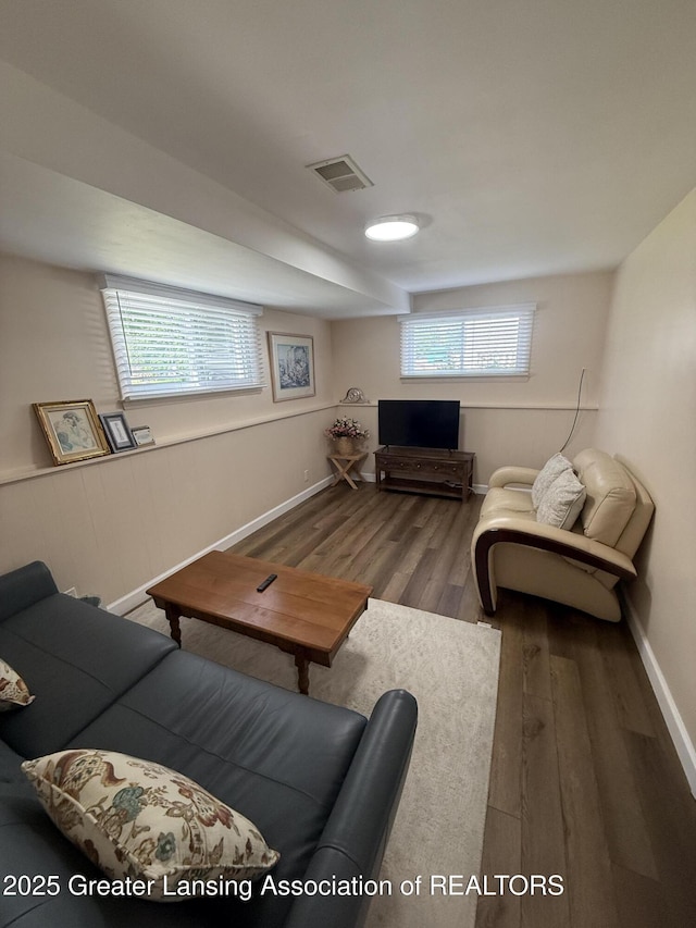 4412 Darron Dr, Lansing, MI 48917 - living room with wood finished floors, plenty of natural light, and baseboards
