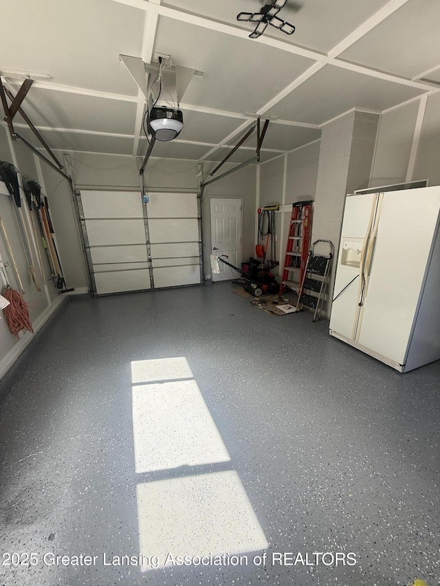 4412 Darron Dr, Lansing, MI 48917 - garage featuring white refrigerator with ice dispenser and a garage door opener