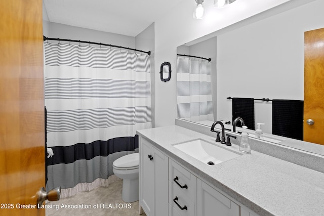 401 Julian Ave, Lansing, MI 48917 - bathroom with vanity, toilet, and curtained shower