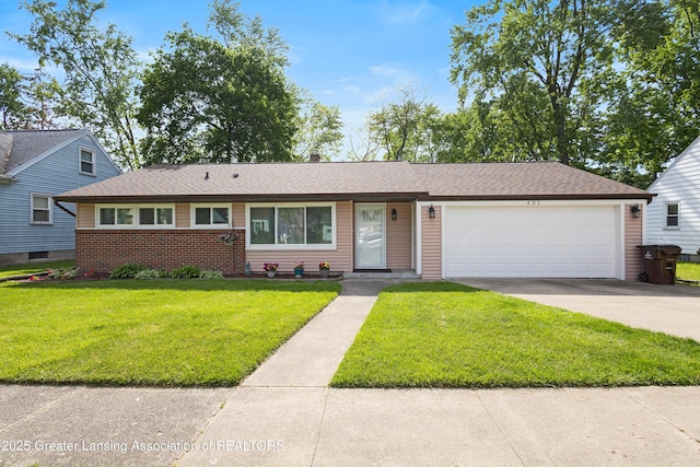 401 Julian Ave, Lansing, MI 48917 - view of front of home with an attached garage, brick siding, driveway, a front yard, and roof with shingles