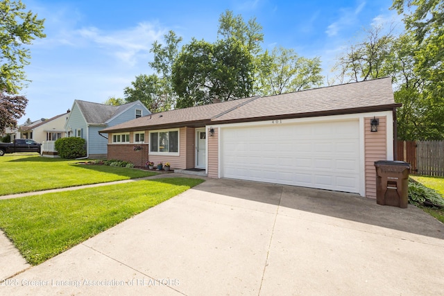 401 Julian Ave, Lansing, MI 48917 - view of front facade with concrete driveway, a garage, and roof with shingles