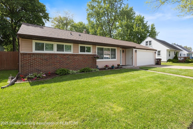 401 Julian Ave, Lansing, MI 48917 - view of front of house featuring brick siding, an attached garage, concrete driveway, and roof with shingles