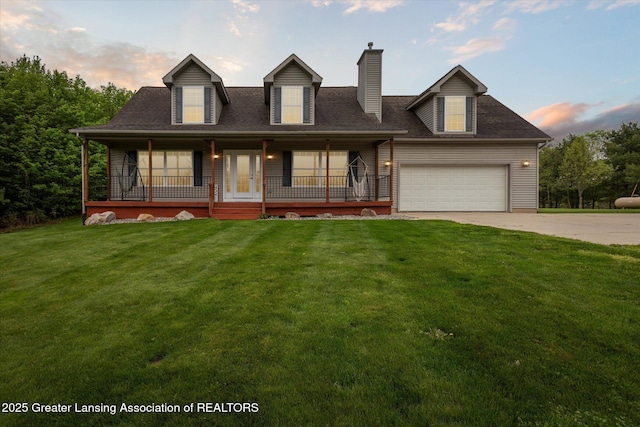 2424 S Canfield Rd, Eaton Rapids, MI 48827 - new england style home featuring driveway, covered porch, a chimney, a front yard, and an attached garage