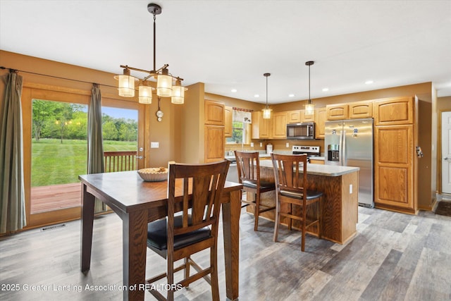 2424 S Canfield Rd, Eaton Rapids, MI 48827 - dining space featuring light wood finished floors, plenty of natural light, and recessed lighting