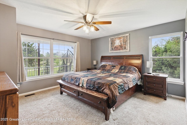2424 S Canfield Rd, Eaton Rapids, MI 48827 - carpeted bedroom with baseboards and a ceiling fan
