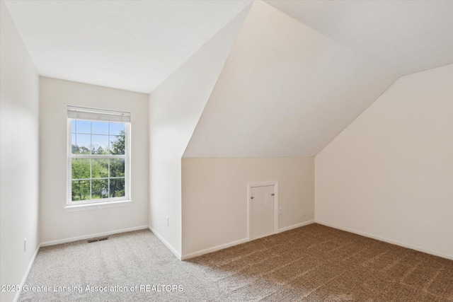 2424 S Canfield Rd, Eaton Rapids, MI 48827 - bonus room featuring carpet floors and vaulted ceiling