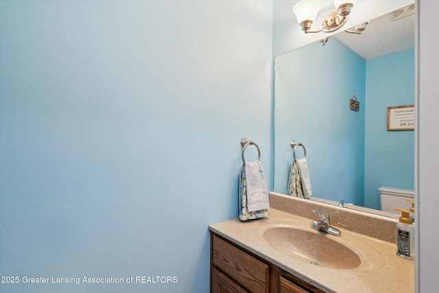 2424 S Canfield Rd, Eaton Rapids, MI 48827 - half bath with vanity and a chandelier
