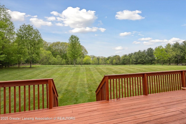 2424 S Canfield Rd, Eaton Rapids, MI 48827 - wooden deck featuring a yard and view of wooded area