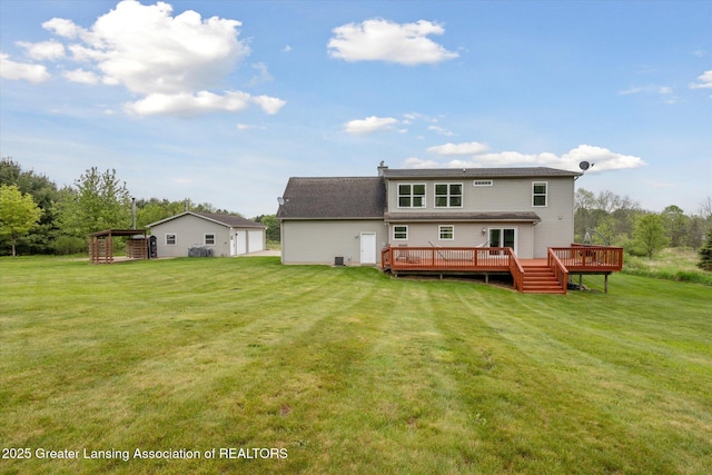 2424 S Canfield Rd, Eaton Rapids, MI 48827 - back of house with a deck, a lawn, and a garage
