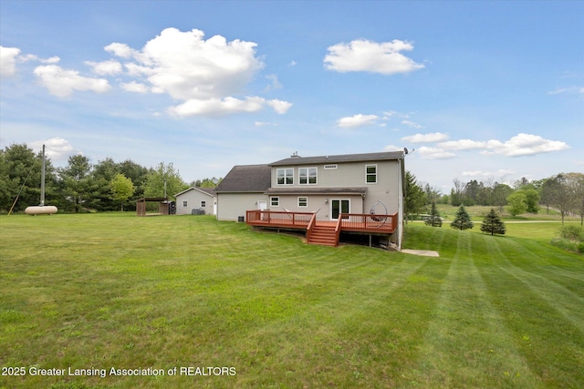 2424 S Canfield Rd, Eaton Rapids, MI 48827 - back of house featuring a wooden deck and a yard