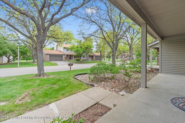 1010 Grenoble Cir, Lansing, MI 48917 - view of grassy yard with a garage