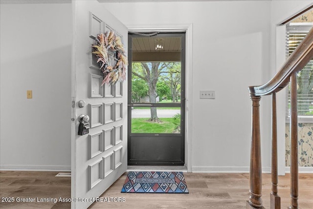 1010 Grenoble Cir, Lansing, MI 48917 - foyer featuring light wood-style flooring, healthy amount of natural light, and baseboards
