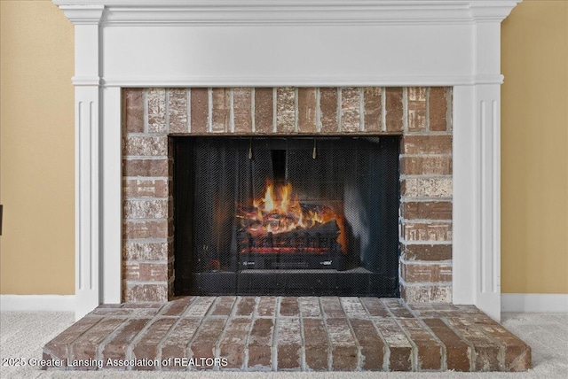 1010 Grenoble Cir, Lansing, MI 48917 - detailed view of a brick fireplace, carpet floors, and baseboards