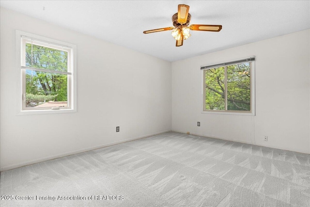 1010 Grenoble Cir, Lansing, MI 48917 - spare room with plenty of natural light, light carpet, and ceiling fan