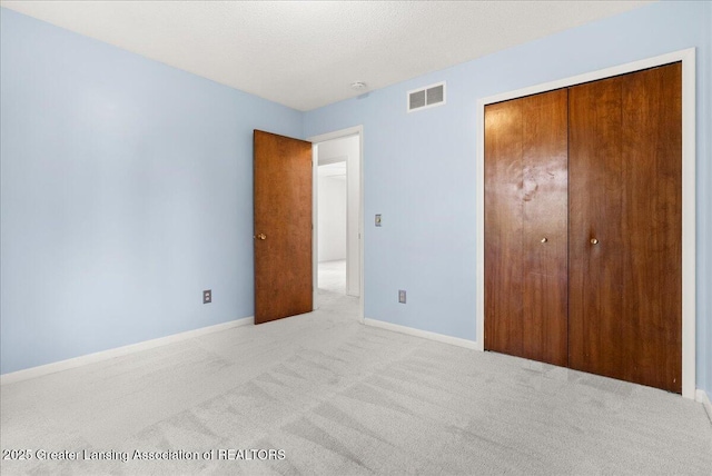 1010 Grenoble Cir, Lansing, MI 48917 - unfurnished bedroom with carpet flooring, baseboards, and a closet