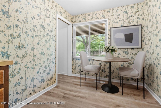 1010 Grenoble Cir, Lansing, MI 48917 - dining room with wallpapered walls, wood finished floors, and baseboards