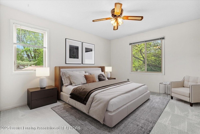1010 Grenoble Cir, Lansing, MI 48917 - carpeted bedroom featuring multiple windows and a ceiling fan