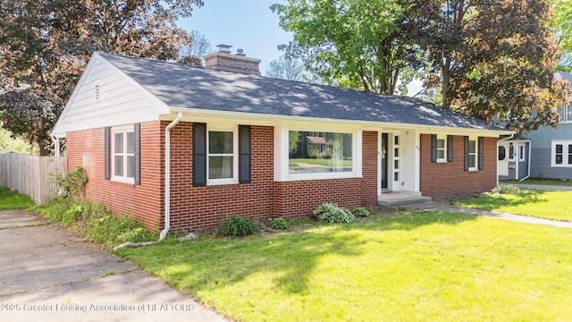 415 W Lawrence Ave, Charlotte, MI 48813 - bungalow-style house with brick siding, a chimney, and roof with shingles