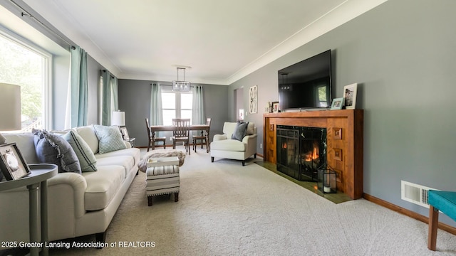 415 W Lawrence Ave, Charlotte, MI 48813 - living area featuring carpet, a fireplace with flush hearth, ornamental molding, and baseboards