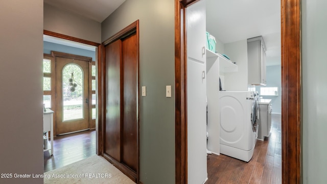 415 W Lawrence Ave, Charlotte, MI 48813 - washroom featuring washing machine and clothes dryer, hardwood / wood-style flooring, cabinet space, and baseboards