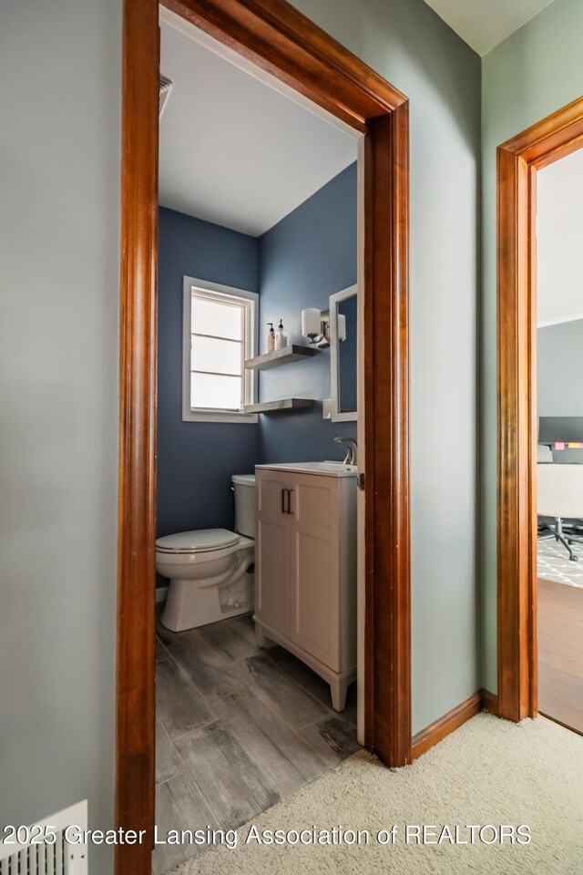 415 W Lawrence Ave, Charlotte, MI 48813 - half bath featuring vanity and toilet