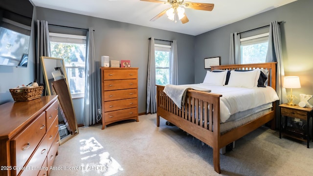 415 W Lawrence Ave, Charlotte, MI 48813 - bedroom featuring light carpet, multiple windows, and a ceiling fan