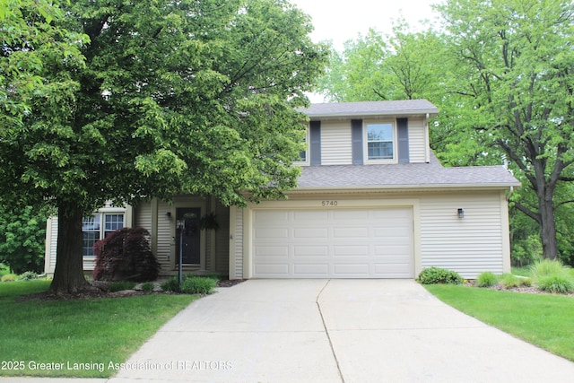 5740 Bearcreek Dr, Lansing, MI 48917 - view of front of property featuring driveway, a front yard, a garage, and a shingled roof