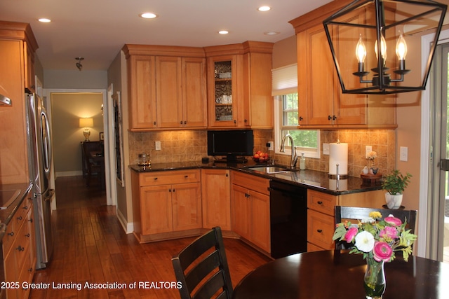 5740 Bearcreek Dr, Lansing, MI 48917 - kitchen featuring dishwasher, a sink, a chandelier, freestanding refrigerator, and dark wood-type flooring