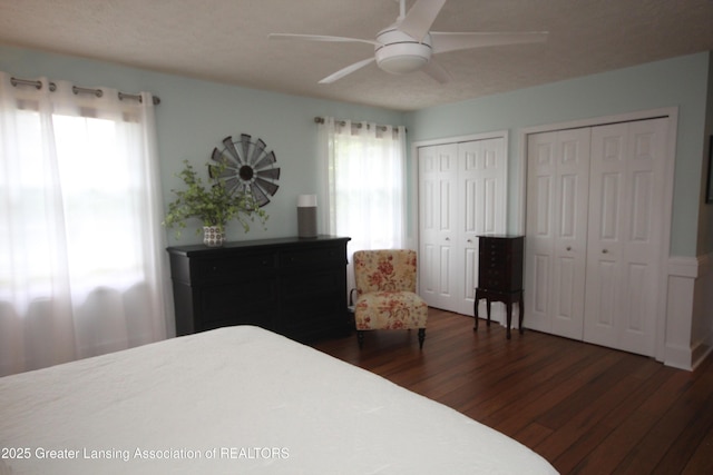 5740 Bearcreek Dr, Lansing, MI 48917 - bedroom with multiple closets, wood finished floors, and a ceiling fan