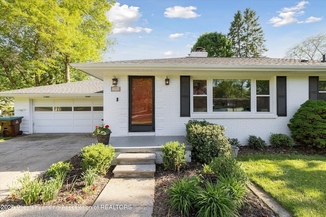 1571 Forest Hills Dr, Okemos, MI 48864 - single story home with brick siding, a garage, concrete driveway, and a chimney