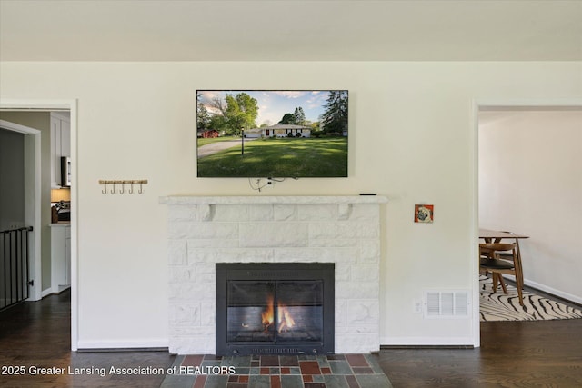 1571 Forest Hills Dr, Okemos, MI 48864 - living area featuring a fireplace, wood finished floors, and baseboards