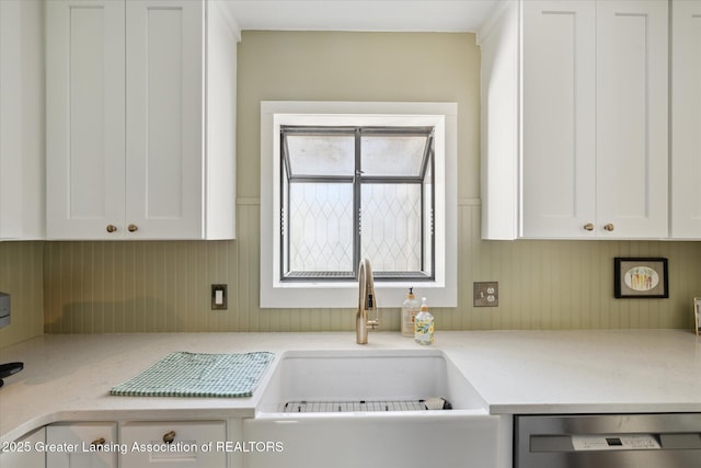 1571 Forest Hills Dr, Okemos, MI 48864 - kitchen with dishwasher, white cabinets, light countertops, and a sink