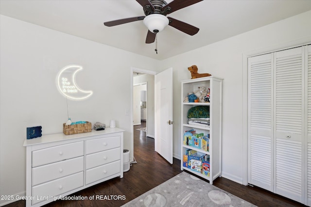 1571 Forest Hills Dr, Okemos, MI 48864 - bedroom with dark wood finished floors, a closet, ceiling fan, and baseboards