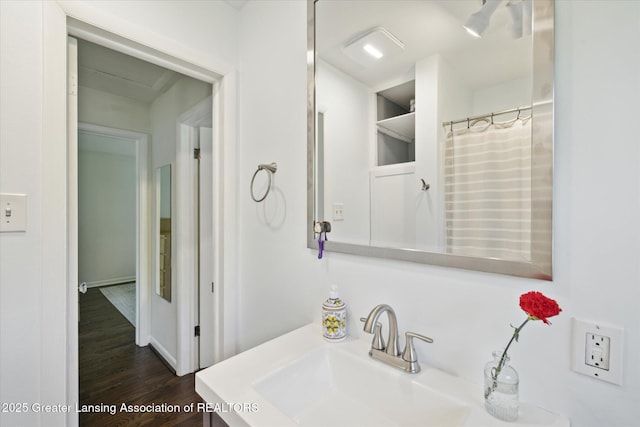 1571 Forest Hills Dr, Okemos, MI 48864 - bathroom featuring a sink and wood finished floors