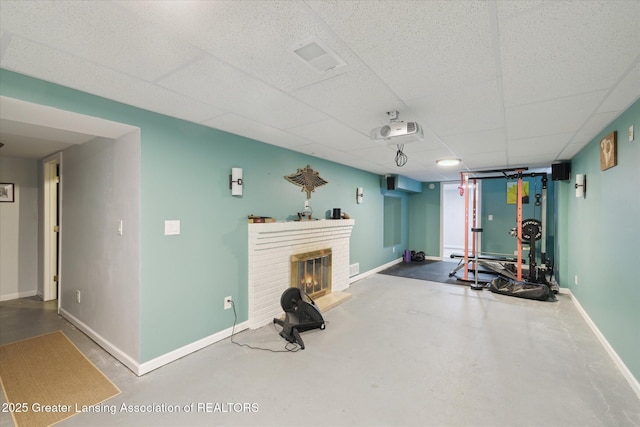 1571 Forest Hills Dr, Okemos, MI 48864 - workout room with baseboards, a fireplace, and a drop ceiling
