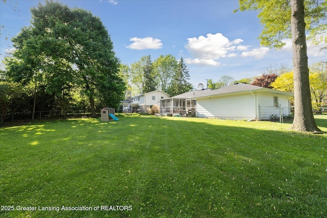 1571 Forest Hills Dr, Okemos, MI 48864 - view of yard featuring a sunroom and a playground