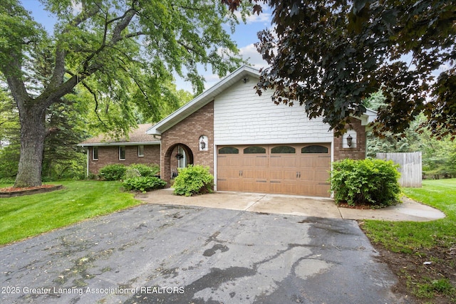 1346 E Howe Rd, Dewitt, MI 48820 - view of front of home with asphalt driveway, brick siding, and an attached garage