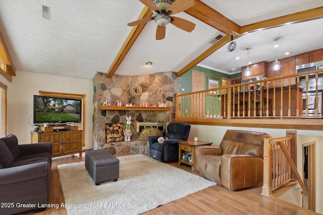 1346 E Howe Rd, Dewitt, MI 48820 - living room featuring wood finished floors, ceiling fan, stairs, and a stone fireplace