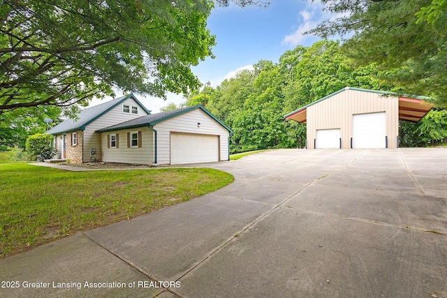 1116 W Service Rd, Mason, MI 48854 - view of front of property with a detached garage and a front yard