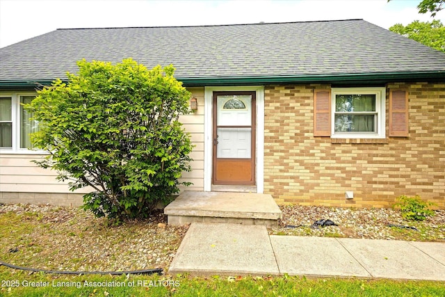 1116 W Service Rd, Mason, MI 48854 - entrance to property with roof with shingles and brick siding
