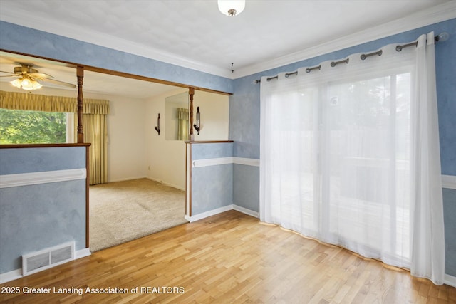 1116 W Service Rd, Mason, MI 48854 - empty room featuring a ceiling fan, wood finished floors, crown molding, and baseboards