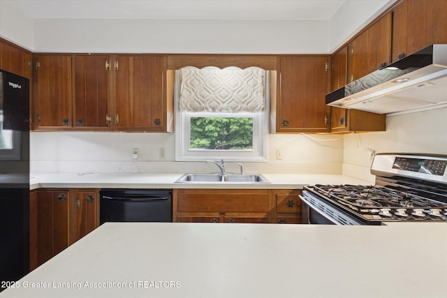 1116 W Service Rd, Mason, MI 48854 - kitchen with stainless steel range with gas stovetop, black dishwasher, a sink, under cabinet range hood, and light countertops