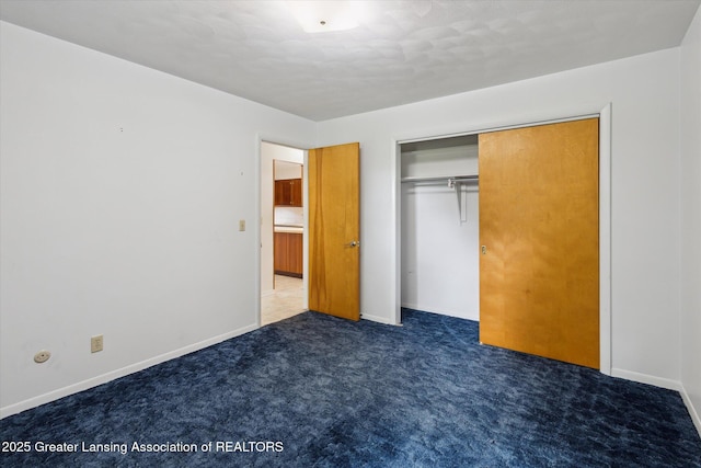1116 W Service Rd, Mason, MI 48854 - unfurnished bedroom with carpet flooring, a closet, and baseboards