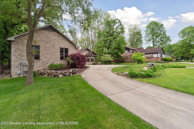 12728 Oneida Woods Trl, Grand Ledge, MI 48837 - view of front of home featuring a front yard and brick siding