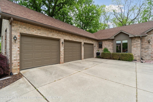 12728 Oneida Woods Trl, Grand Ledge, MI 48837 - view of front of home featuring roof with shingles, concrete driveway, an attached garage, and brick siding