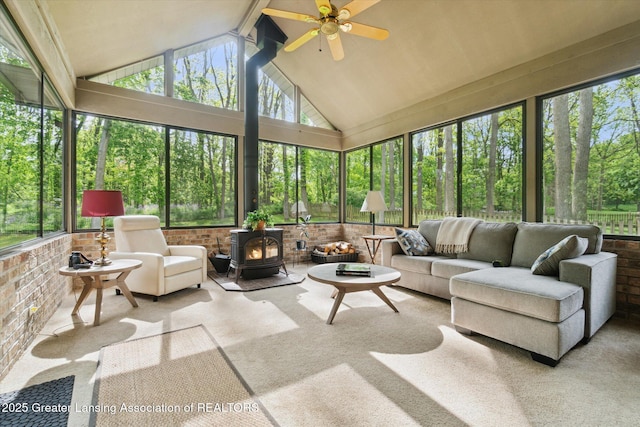 12728 Oneida Woods Trl, Grand Ledge, MI 48837 - sunroom with a wood stove, a ceiling fan, outdoor lounge area, carpet floors, and brick wall