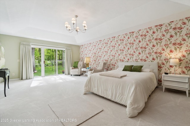 12728 Oneida Woods Trl, Grand Ledge, MI 48837 - carpeted bedroom featuring a chandelier, wallpapered walls, access to exterior, and a tray ceiling