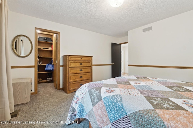 12728 Oneida Woods Trl, Grand Ledge, MI 48837 - bedroom with a spacious closet, light carpet, a closet, and a textured ceiling