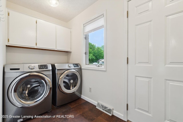 12728 Oneida Woods Trl, Grand Ledge, MI 48837 - laundry area with cabinet space, washing machine and clothes dryer, baseboards, and a textured ceiling