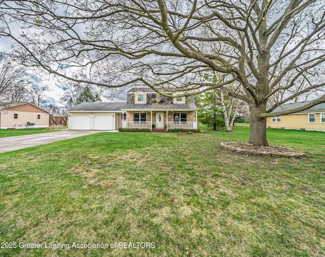 1932 Maple Shade Dr, Williamston, MI 48895 - traditional home with covered porch, driveway, a front yard, and an attached garage